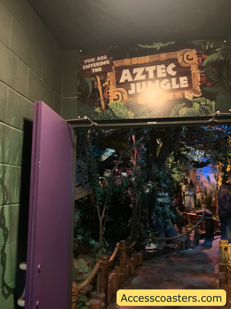 Image of the door leading into the Aztec Jungle. The door is purple and propped open. There is an Aztec Jungle sign above the door.