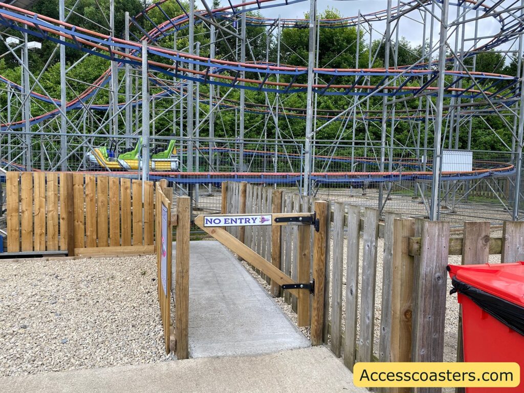 image shows exit/ride easy access pass entrance for rocket rollercoaster. in the image you can see a gate saying no entry with a path leading up to the ride exit 