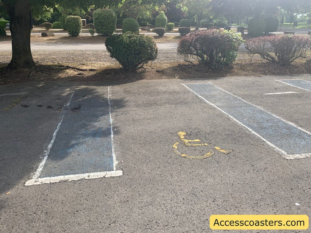 image shows blue badge parking space in the image you can see the yellow wheelchair symbol in the middle of the parking spot with blue hatching either side 