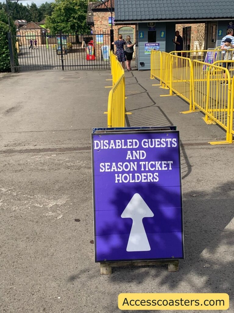 in the image you can see a straight queueline with a sign saying disabled guests and season pass holders