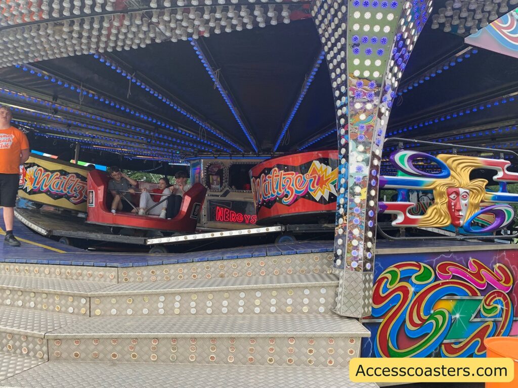 in the image you can  see steps leafing up to the waltzers as well as the ride cars 