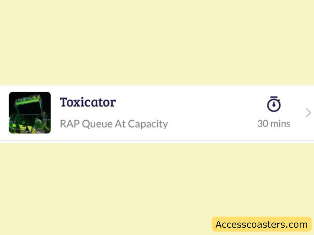 A section of a webpage or app interface shows information about "Toxicator." There is a small image on the left, which appears to be a ride or attraction with green and black colors. The text next to the image reads "Toxicator" in bold, followed by "RAP Queue At Capacity" in lighter text. On the right side, there is an icon of a clock with "30 mins" next to it, indicating a wait time. At the bottom right corner, there is a watermark with the text "Accesscoasters.com" in a yellow box.