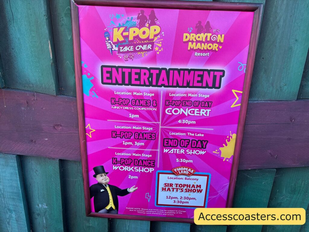 Pink and purple “K‑Pop Take Over” poster for Drayton Manor Resort listing entertainment times: K‑Pop Games & Fancy Dress Competition (1pm), K‑Pop Games (1pm and 3pm), K‑Pop Dance Workshop (2pm), End of Day Concert (4:30pm), End of Day Water Show at the lake (5:30pm), and Thomas Land’s Sir Topham Hatt’s Show on the balcony (12pm, 2:30pm, 3:30pm).