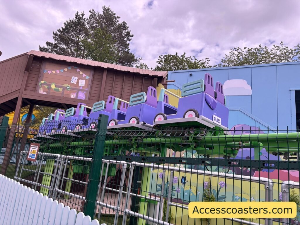 image of back of bluey the ride train on the track that is green the train is empty with no riders as was testing