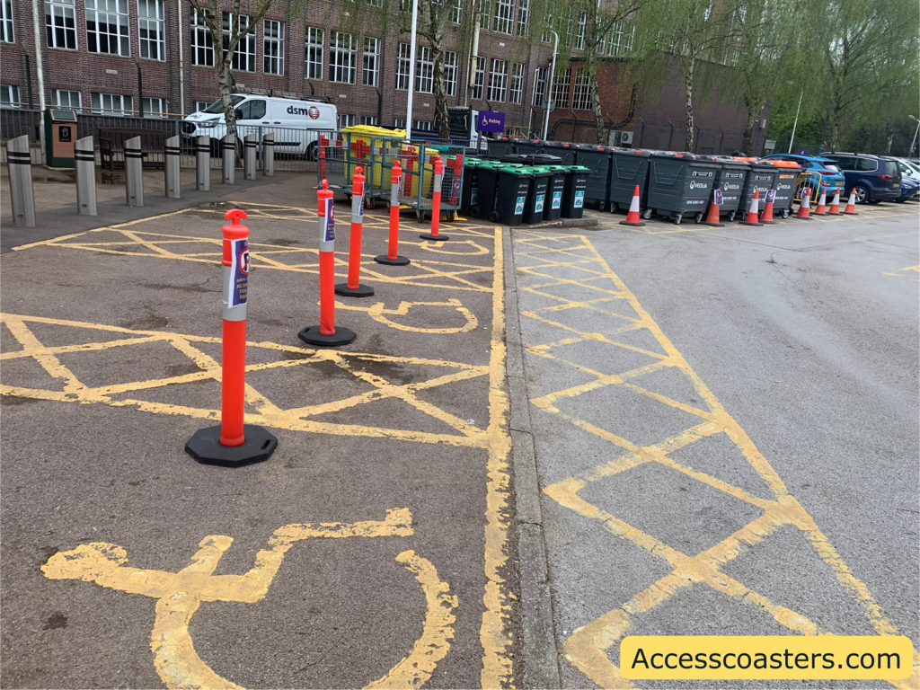 Image shows blue badge spaces blocked off with cones and bins