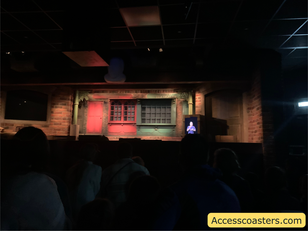 Image of Cadbury story screen where the show is played. On the screen you can see a scene of an old town as well as a BSL interpreter in the corner. 
