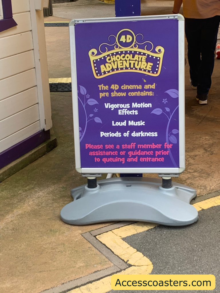 Sign outside the 4D chocolate adventure that says ‘the 4D cinema and pre show contains: vigorous motion effects, loud music, periods of darkness, please see a staff member for assistance or guidance prior to entering the queue. 
