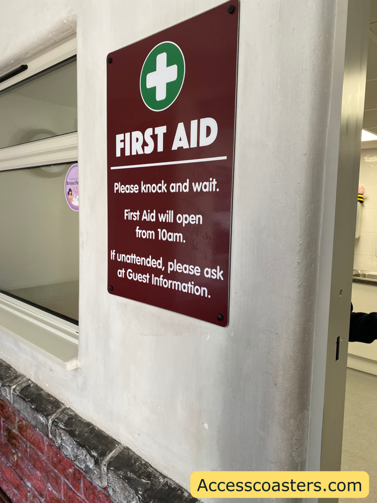 Image of First Aid centre sign saying that it open at 10am and if closed go to gust services. 