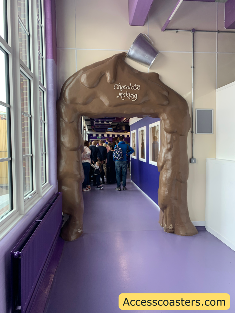 Image of the entrance to the chocolate making area. The entrance sign looks like melted chocolate coming down the wall
