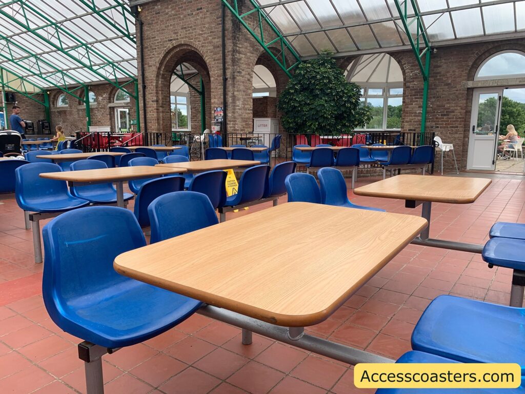 image of seating area at the grill. in the image you can see a large seating area with tables and chairs. 