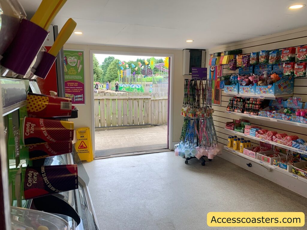 image shows the inside of the caterpillar shop with door leading to ride exit. 