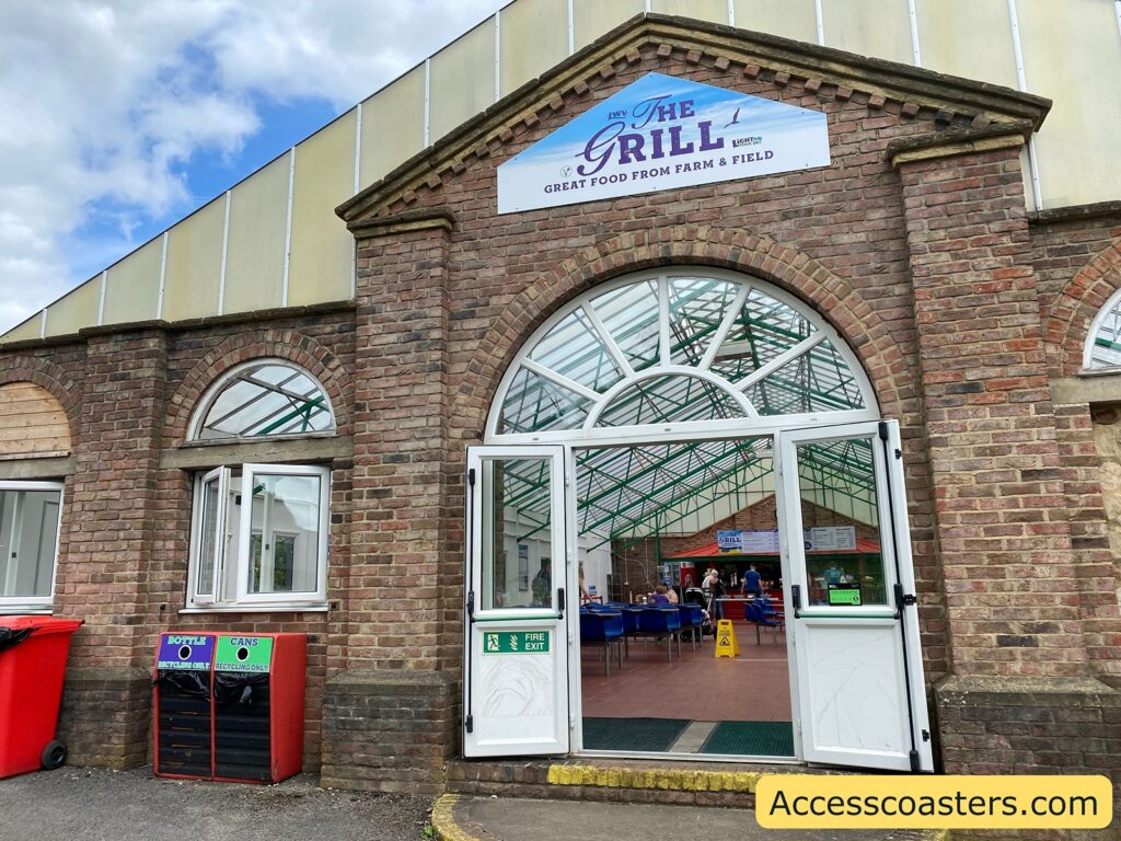 image shows the entrance to the grill restrant you can see doors leading into the  restraint and a sign above the door saying the grill. 