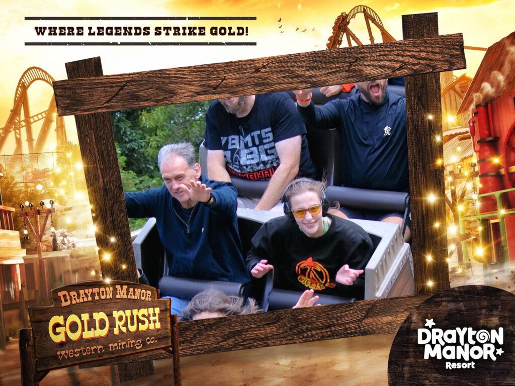 image of Iona and dad gold rush on ride photo both smiling at the camera