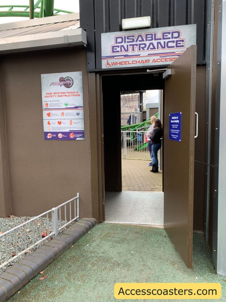 in the image you can see a door leading through to a queue line with a sign that reads disabled entrance.