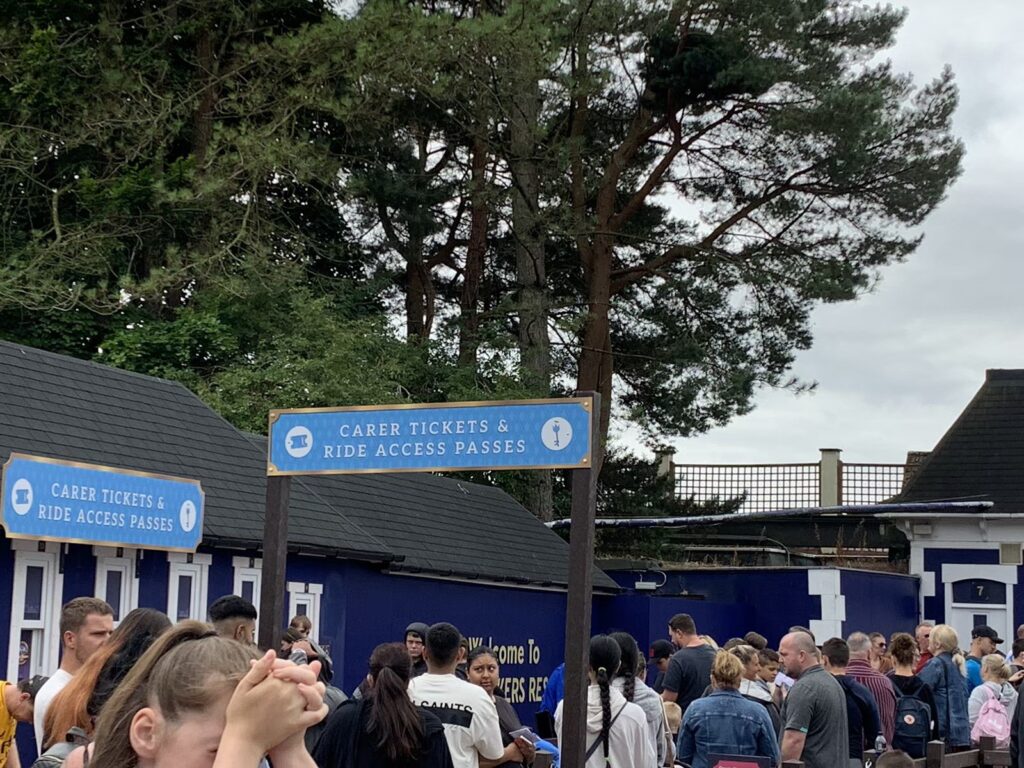 image of ride access pass and carer kiosk and queue line