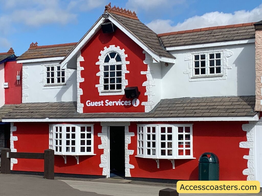 close up image of the outside of guest services you can see a red building with a sign that says guest services