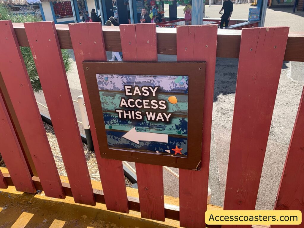 image shows a sign in wave swinger exit that reads easy access this way 