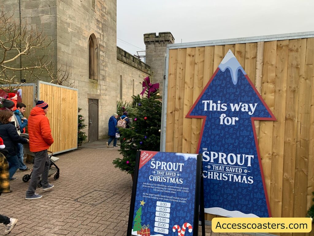 in this image you can see the entry way into the show area you can see a path and a big arrow that says this way for sprout that saved Christmas