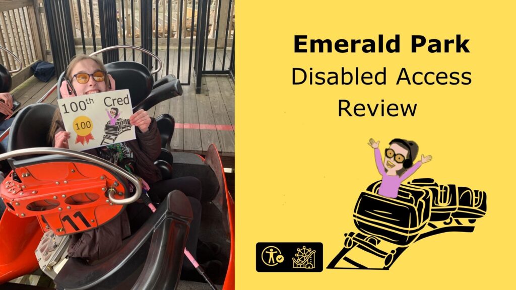Iona sitting in a roller coaster car, smiling widely. She is wearing pink ear defenders and orange-tinted glasses, and holding a sign that reads "100th Cred" with a gold ribbon marked "100" and a cartoon of herself riding a roller coaster. The roller coaster car is black and orange, marked with the number 11. The background shows wooden decking and metal railings. On the right side of the image, a yellow background features bold black text: "Emerald Park Disabled Access Review." There is a cartoon of the same woman, arms raised, riding a stylized roller coaster. At the bottom are two icons: one representing accessibility, and the other a roller coaster.