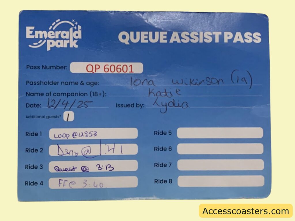 A blue rectangular card labeled "Emerald Park Queue Assist Pass." The card has printed and handwritten information.

Printed sections include:
- Pass Number: QP 60601 (in a red-bordered box)
- Passholder name & age: Iona Wilkinson (19) (handwritten)
- Name of companion (18+): Katie (handwritten)
- Date: 12/4/25 (handwritten)
- Issued by: Lydia (handwritten)
- Additional guests: 1 (in a white circle)

There are eight ride slots, with the first four filled in by hand:
Ride 1: Loop @ 12:53
Ride 2: Dzn @ 1:41
Ride 3: Quest @ 3:13
Ride 4: FF @ 3:40

The remaining ride slots (5 to 8) are blank.
