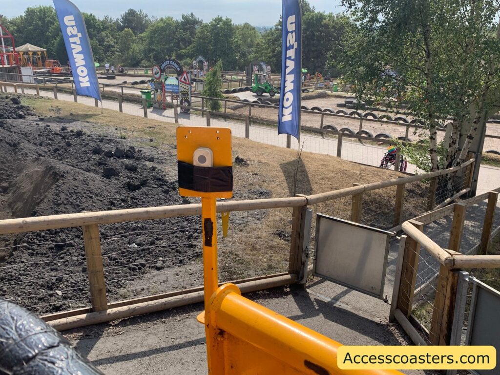 image of the ride on the ground you can see the yellow ride vhcal with a doorbell button to ask fror helo