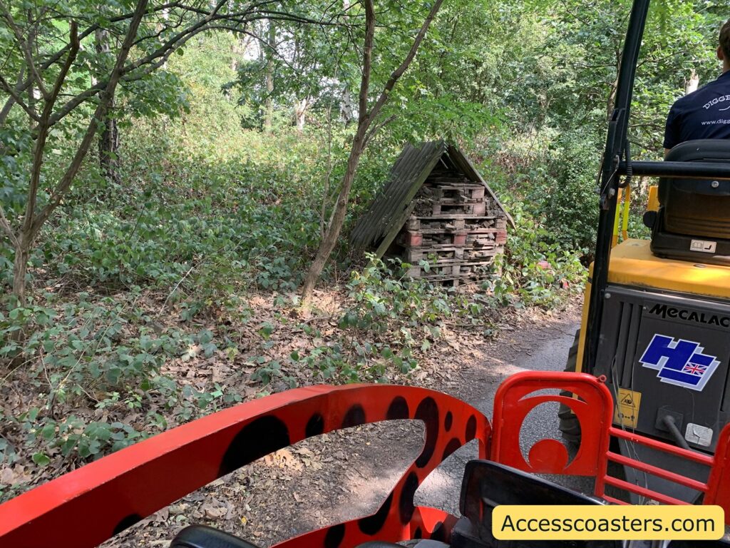 bug house serounded by trees at the side of train ride