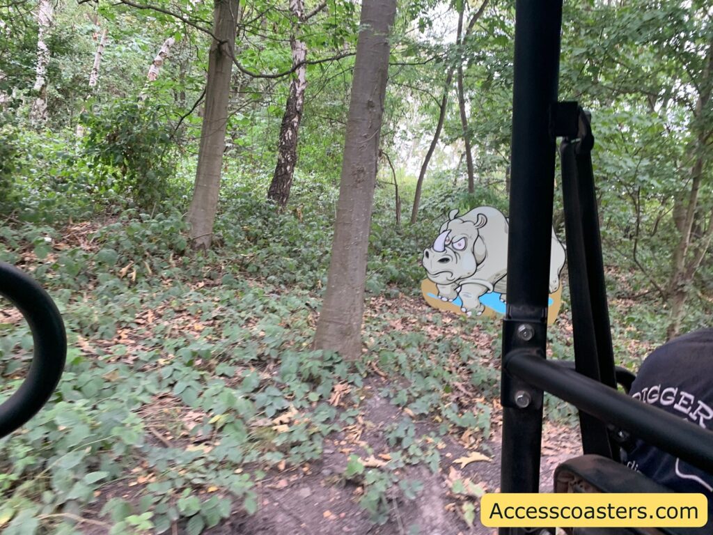 image of woodlend view from safari whical with an cut out of an elephant visable to the side