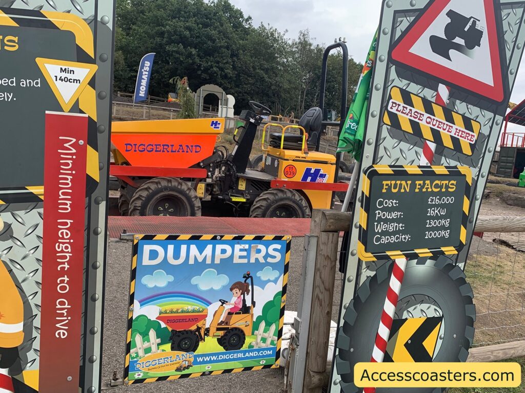 entrance gate for dumpers ride. Signage around the gate reads Minimum height to drive Min 140cm PLEASE QUEUE HERE FUN FACTS Cost: £16,000 Power: 26kW Weight: 1300kg Capacity: 1000kg DUMPERS DIGGERLAND
