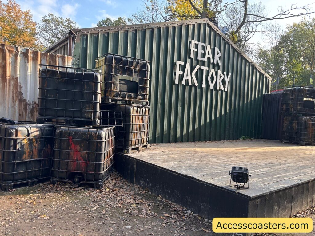 A wide view of the stage area called "Fear Factory," showing stacked containers and an empty stage set 