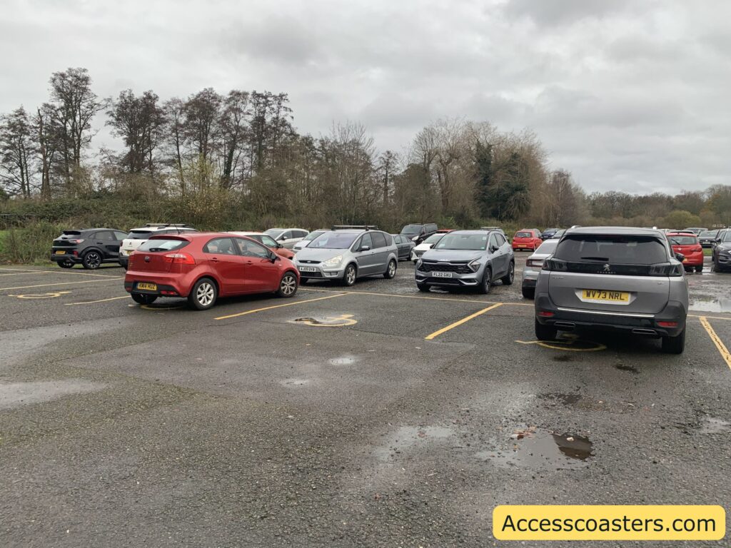 Accessible blue badge parking spaces at Drayton Manor, featuring multiple cars parked on a flat, hardstanding surface. 