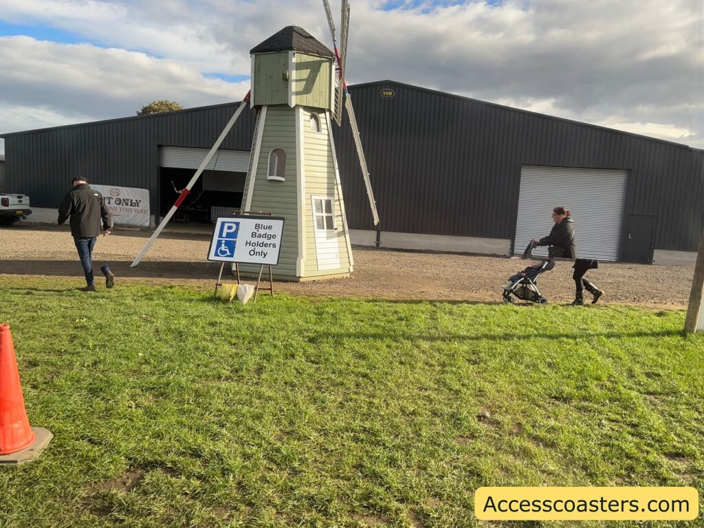 View of a large open parking area with blue badge parking sign