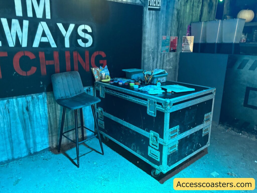 nterior setup at the face painting area with blue lighting, chairs, and equipment cases