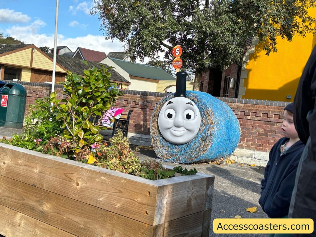A blue hay bale painted to resemble Thomas the Tank Engine