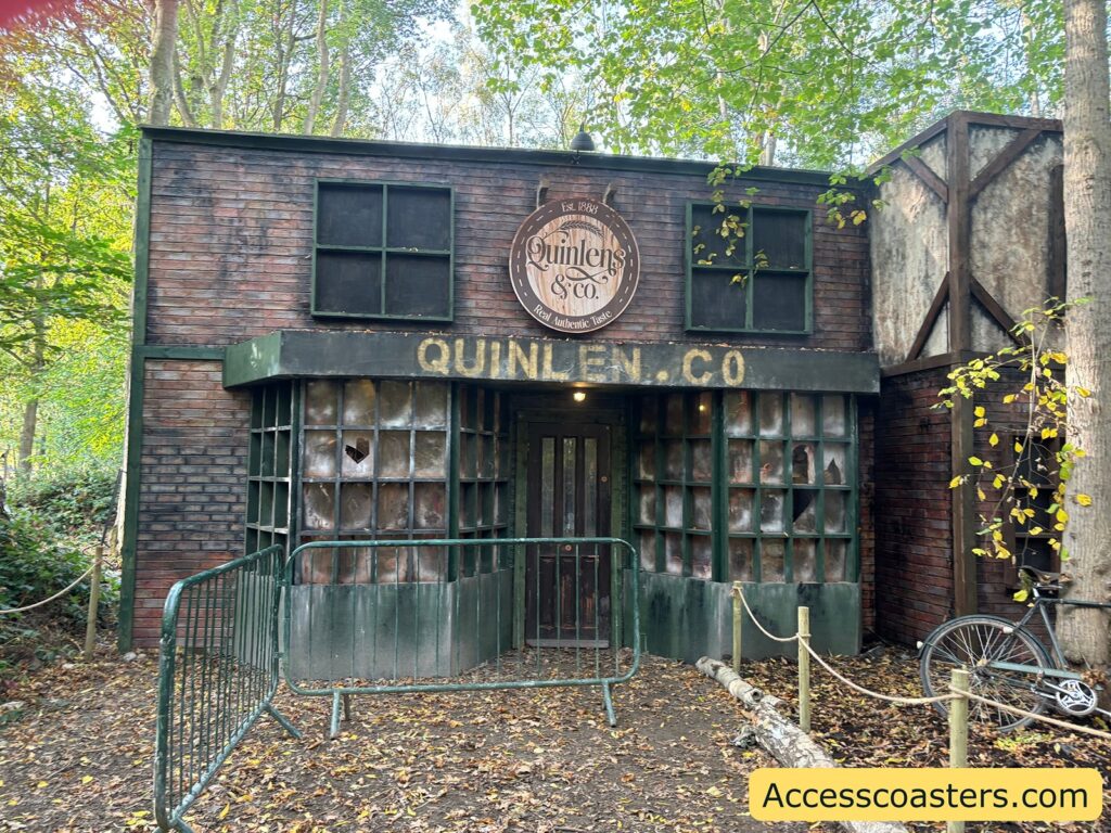 Exterior view of the Quinlens & Co maze building, styled like an old bakery with wooden features and a sign above the entrance.