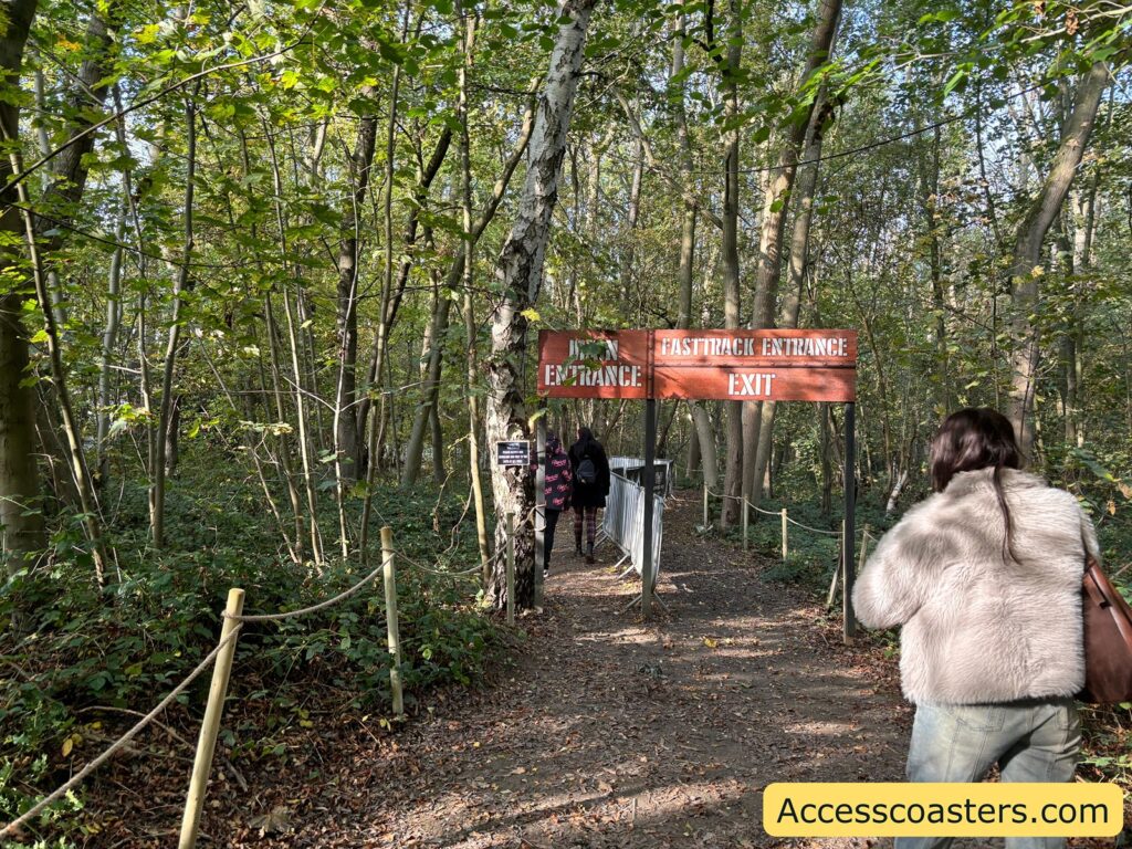 rope-lined path in the woods towards the entrance of the Quinlens & Co maze, with a sign visible ahead.