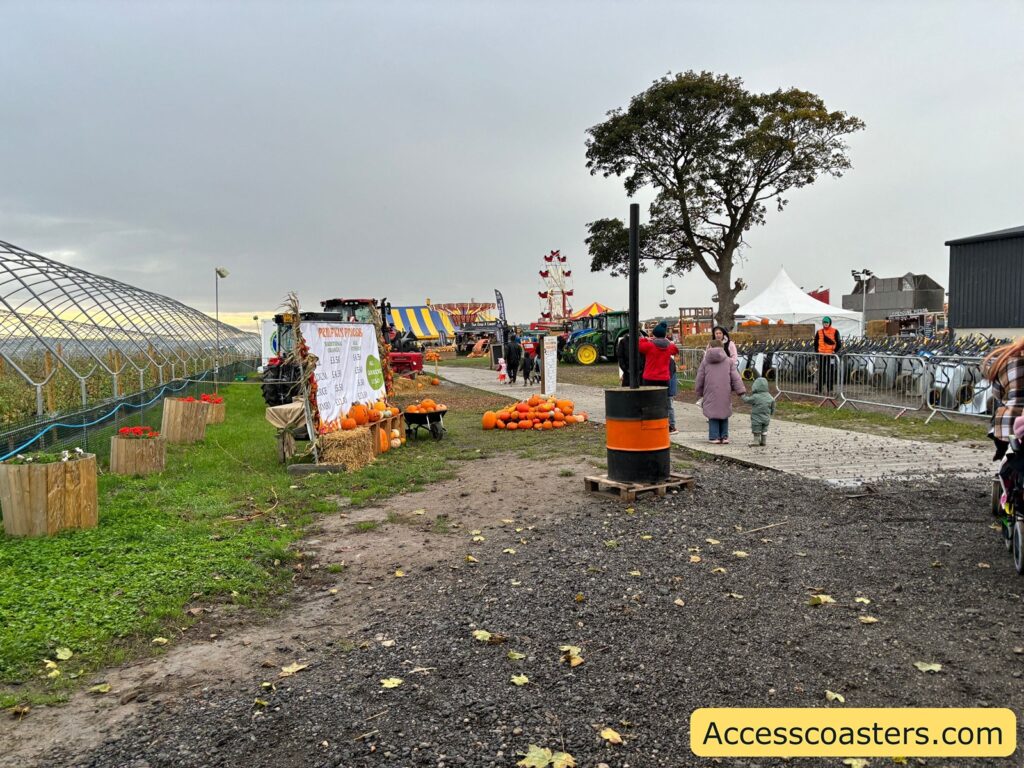 Entrance path with signage and staff directing visitors at the admissions area