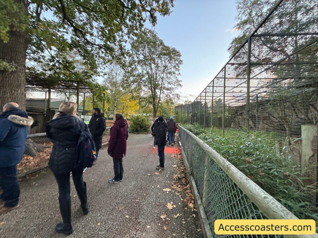 wide, flat path next to a fenced animal area