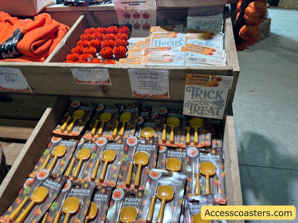 Close-up of baskets of orange and green fabric hats or bags, and a crate labeled "TRICK OR TREAT."