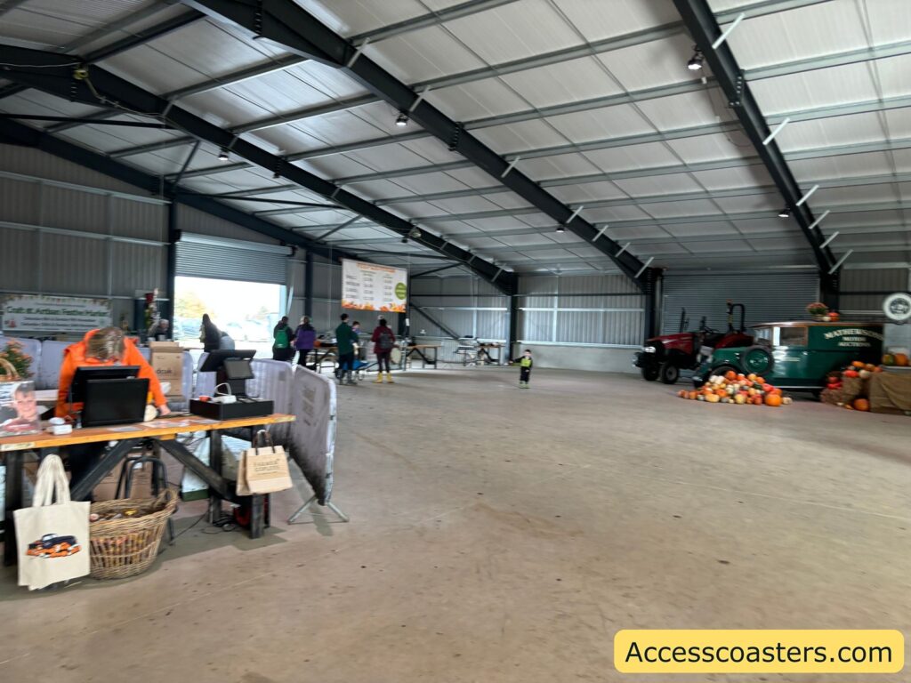 Wide shot showing more of the warehouse space and pumkin paying area with displays and shopping areas.