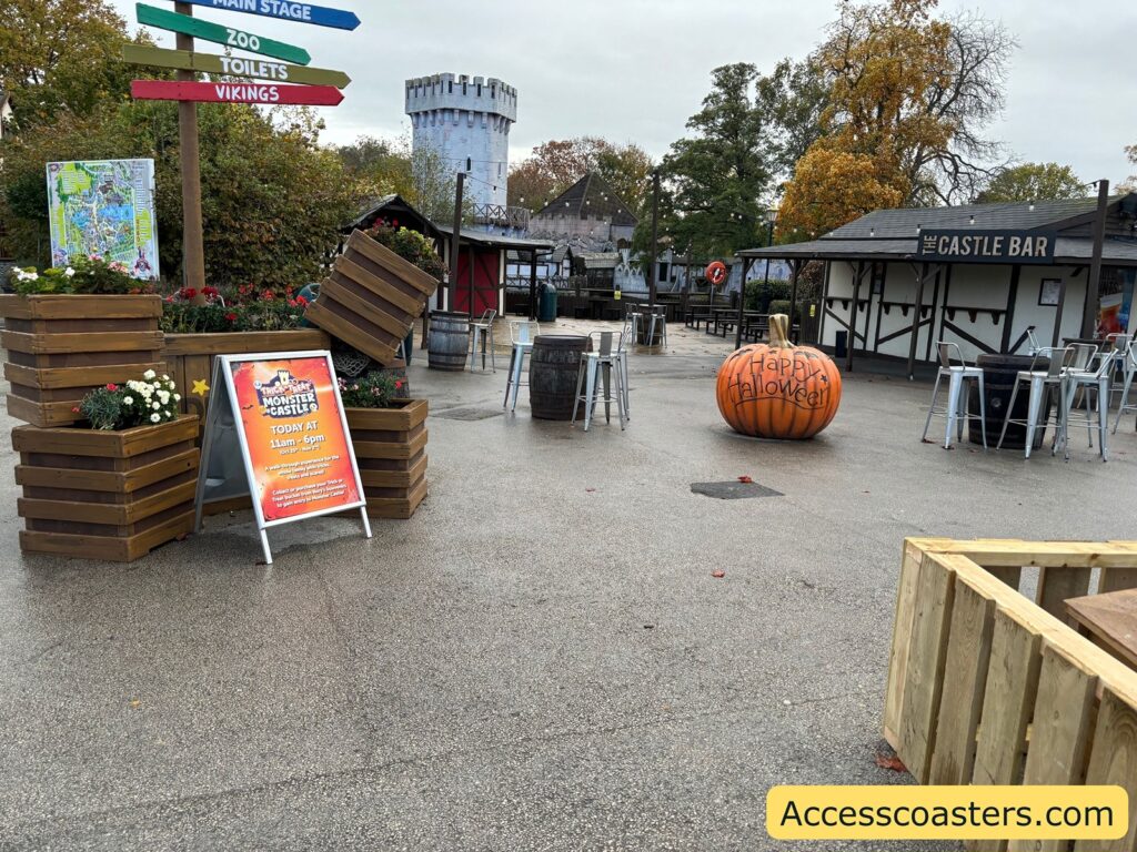 View of the outside of the castle near the entrance, with Halloween decorations and signs with opening times