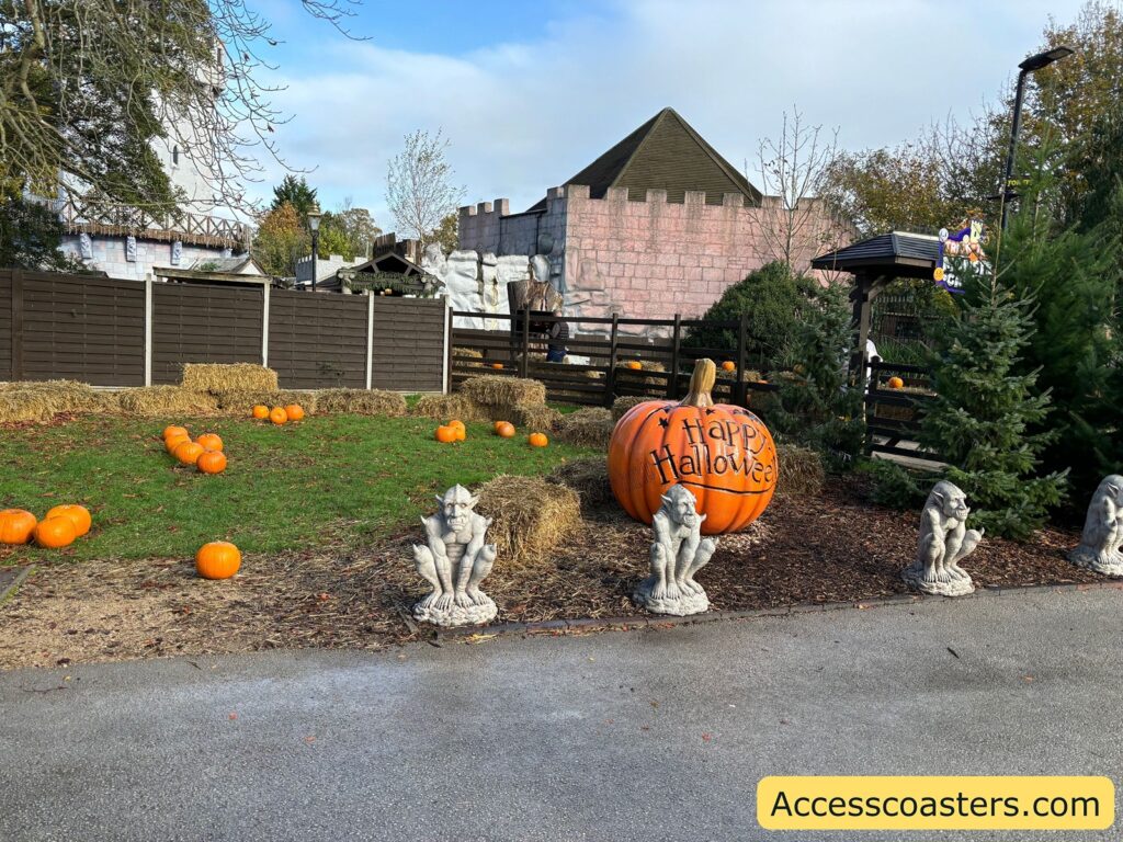Pathway leading towards the castle, lined with large pumpkins and festive decorations