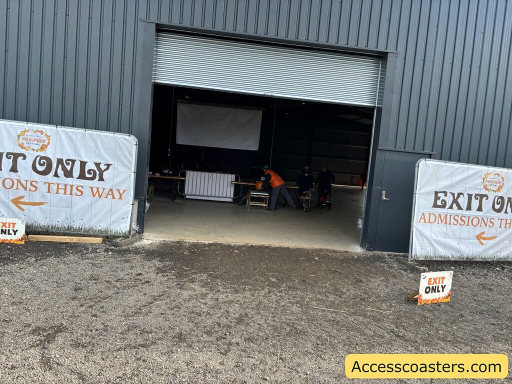 Shop exit doors with handwritten "EXIT ONLY" signs and a pumpkin display