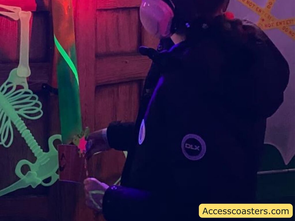 Iona at the treat shoot station, illuminated by neon-green decorations and UV lighting.