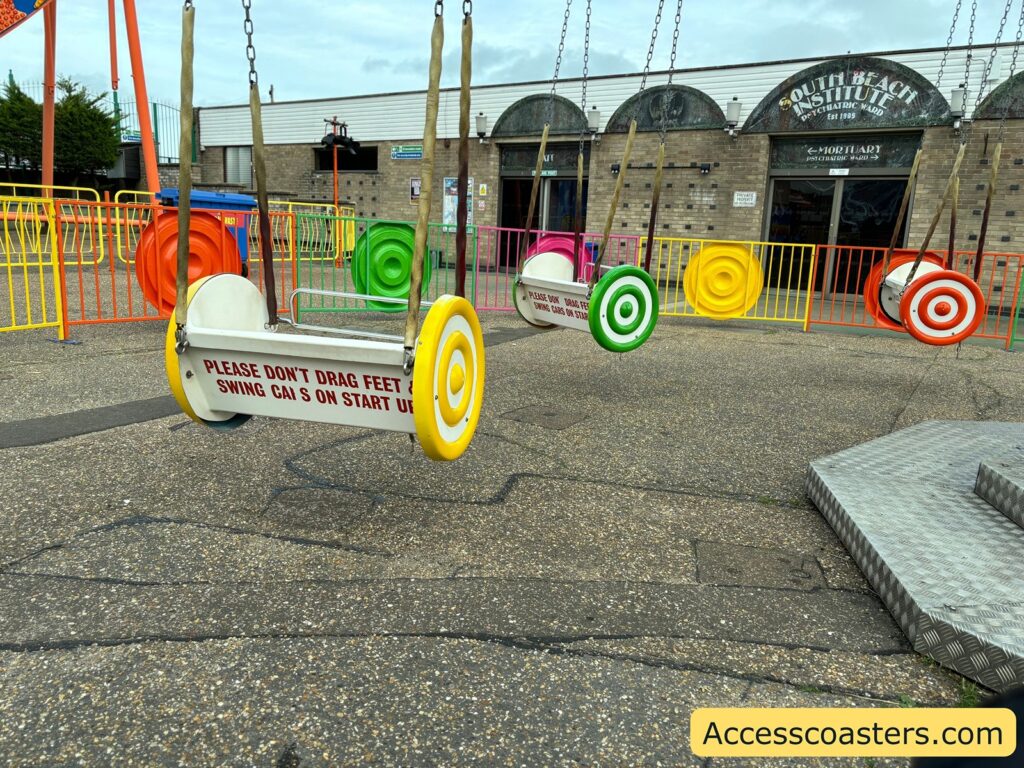 The Yo-Yo Ride itself, showing several suspended swing chairs decorated with large, colorful circles, arranged in a circle 