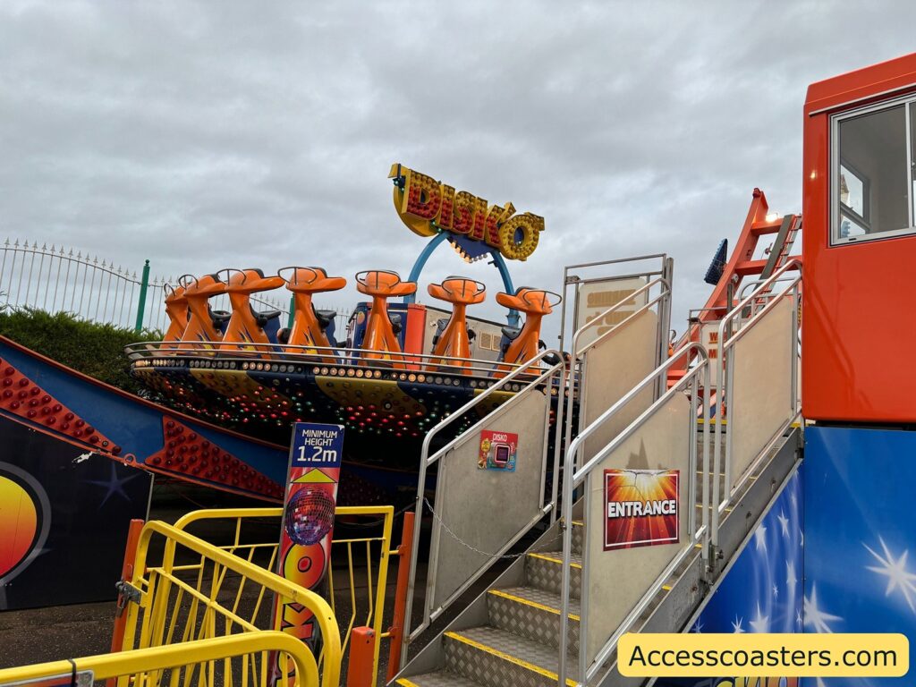 Stairs with a handrail leading up to the Disko ride’s platform