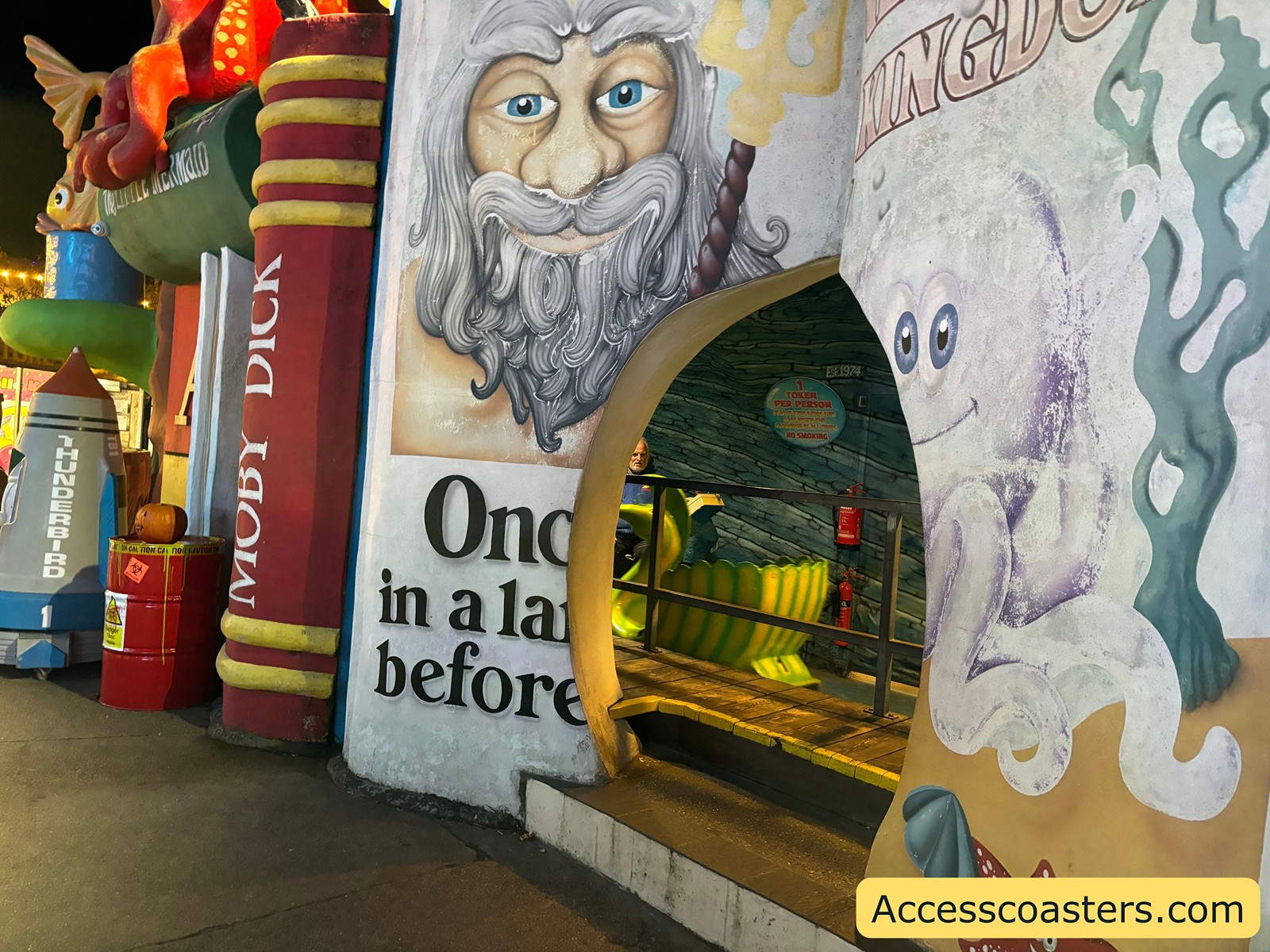 The colorful entrance to Neptune’s Kingdom ride, decorated with a painted mural of a bearded Neptune face and underwater-themed artwork.