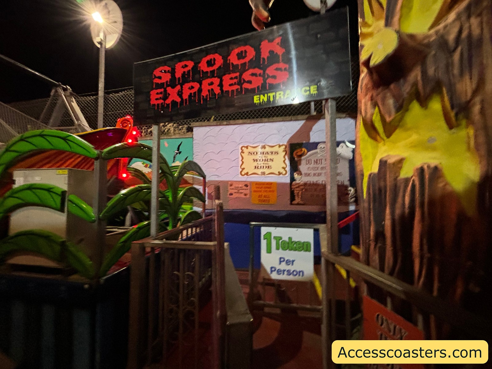 Entrance to the Spooky Express rollercoaster, showing colorful theming and the sign for the ride inside Joyland.