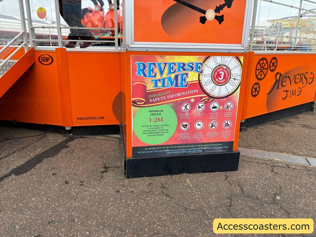 entrance sign for the Reverse Time ride, showing safety instructions and ride branding.