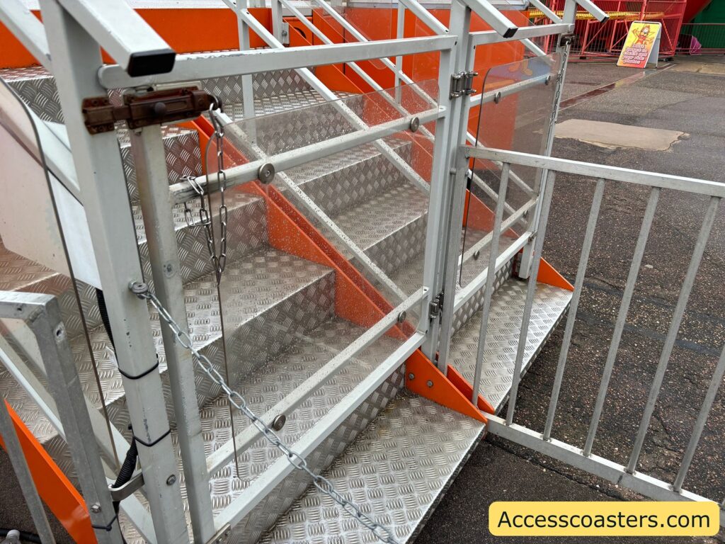 metal stairs with a handrail leading up to the Reverse Time ride platform.