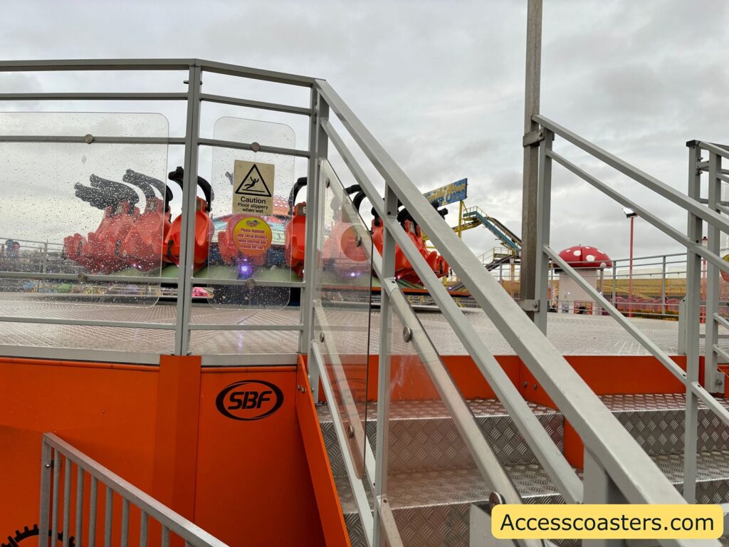 View of the ride platform and seats for Reverse Time, showing safety restraints 